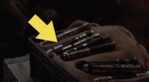 Case of lightsabers with arrow pointing to Quinlan Vos'