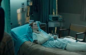 Max lays comatose in hospital